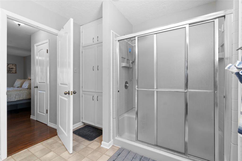 Walk in shower; linen storage and 2 closets connected