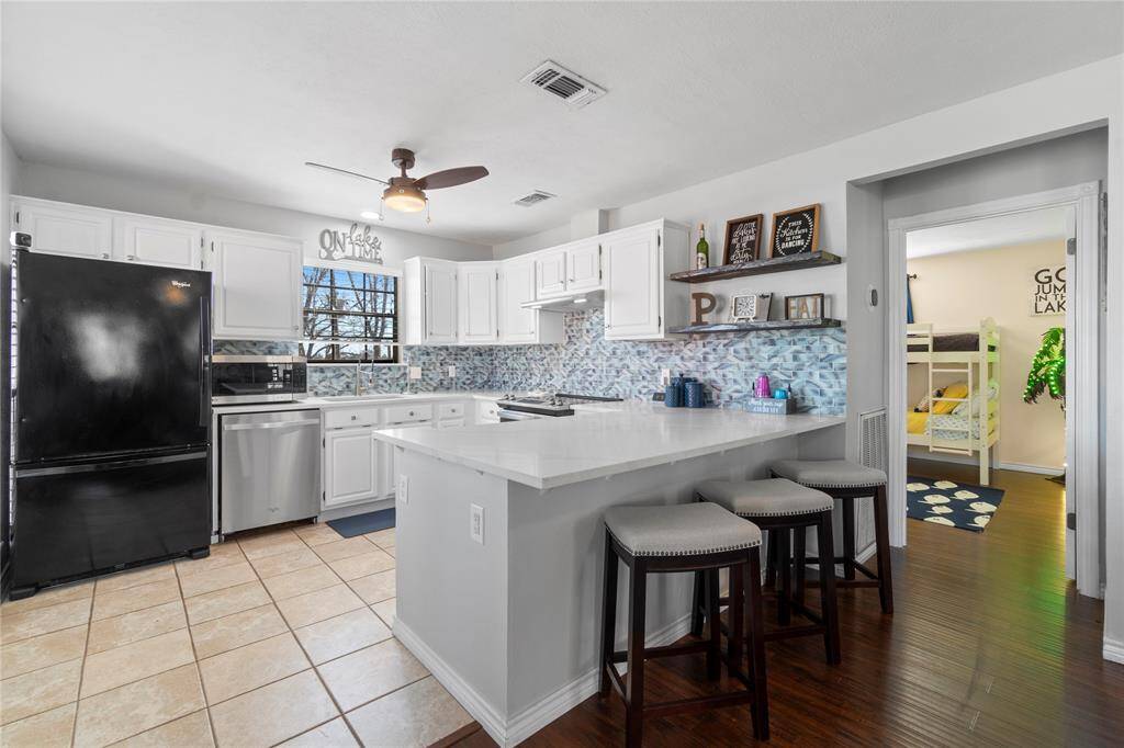 Freshly remodeled kitchen with quartz counters and white cabinets