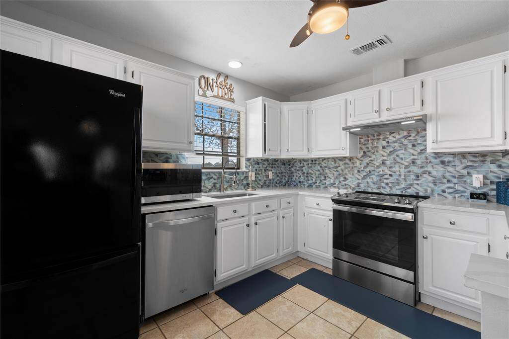 Refrigerator stays with the house; window out to the lake