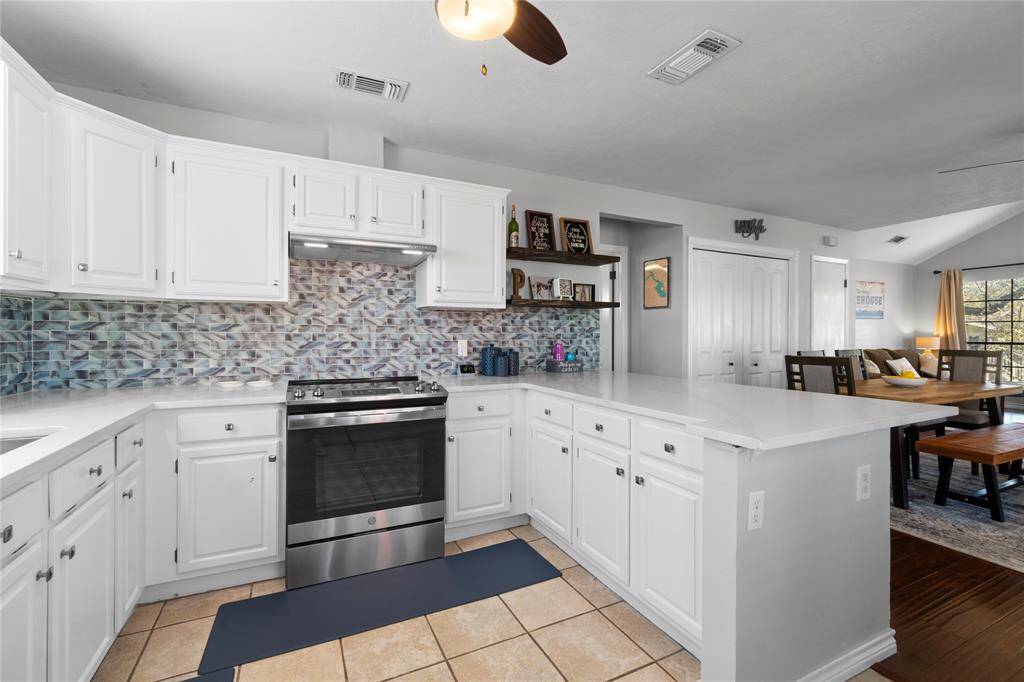 Gorgeous shades of blue backsplash and large breakfast bar