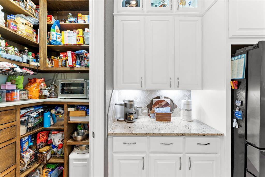 Custom stained maple pantry with outlets inside to house and power any small size appliances, like an air fryer or toaster oven.