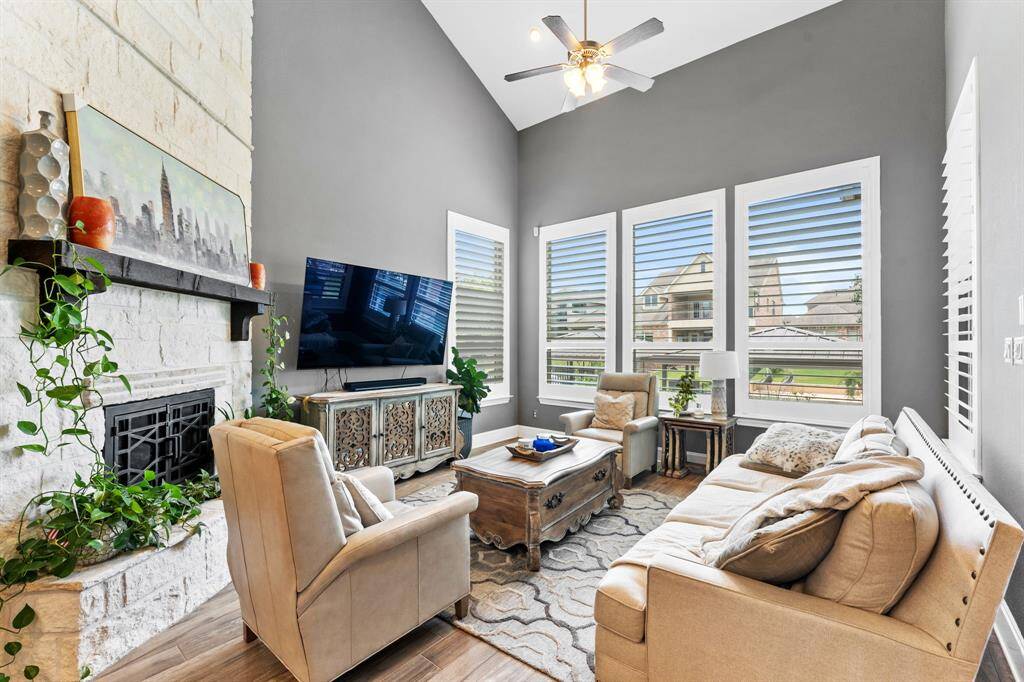 The stone fireplace has gas logs with custom iron doors and extends 24' to the ceiling.