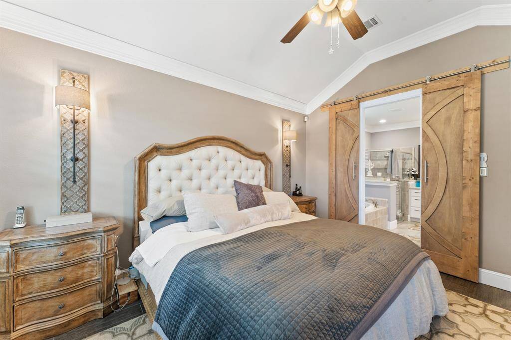 Primary Bedroom with custom barn doors leading into the bath.