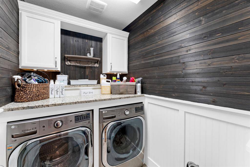 Laundry room has stained cedar tongue and groove, led lighted cabinets, and 2 matching granite counters.