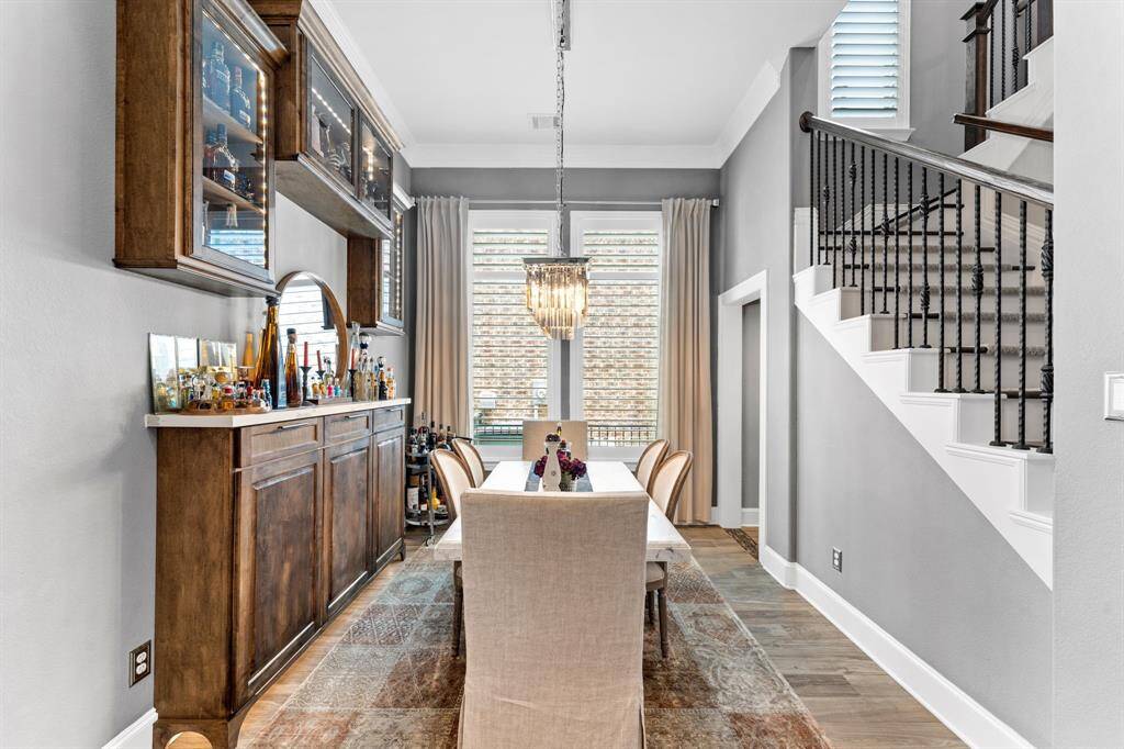 Like a photo from a magazine with custom built in buffet, led lighted glass cabinets and Restoration Hardware chandelier. Don't miss the custom bar to the right, under the stairs!