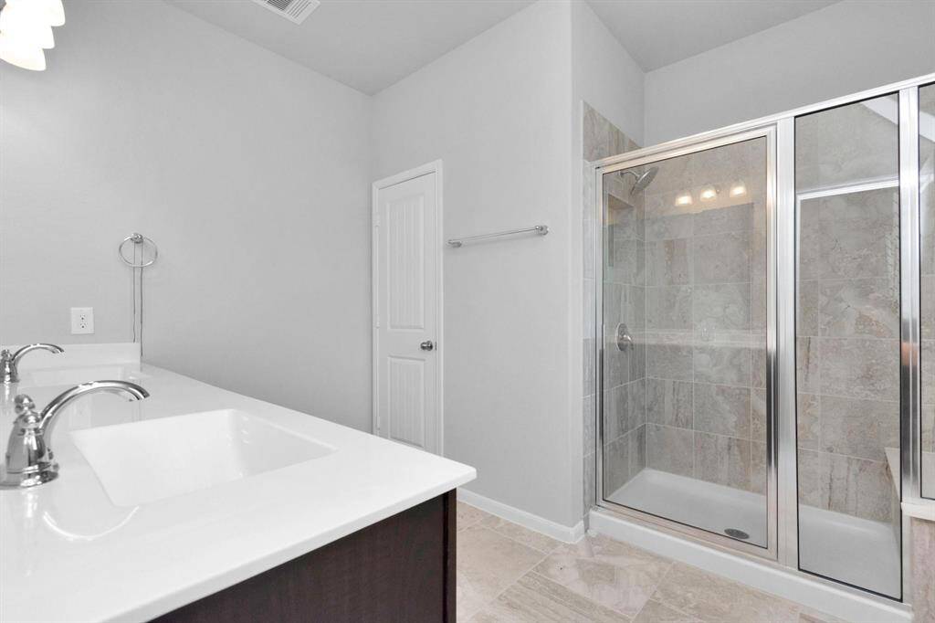 Primary Bathroom has large walk in shower and seating