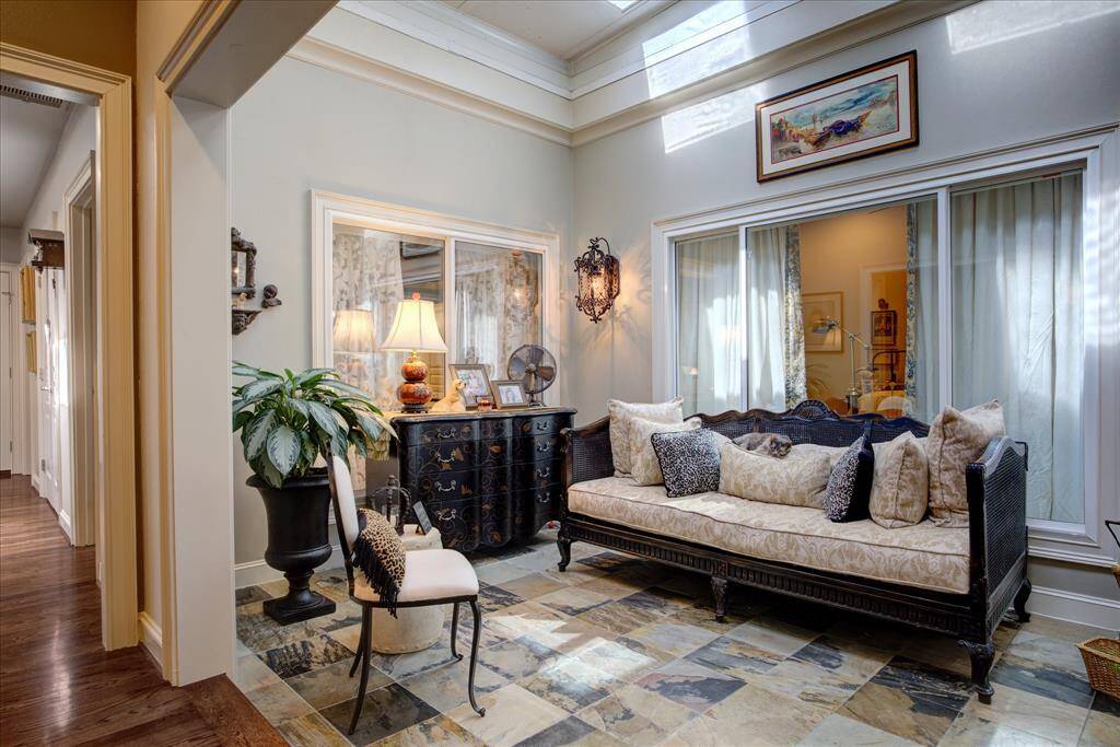 Across from the dining room is the sunroom with slate flooring and iron scones.