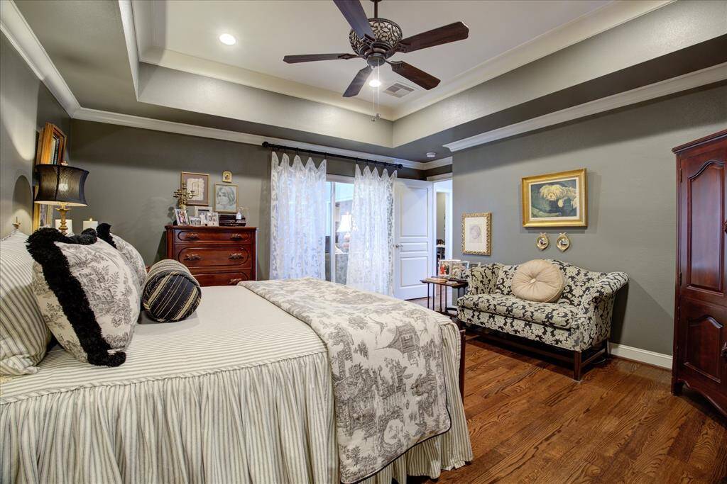 Another view of the primary bedroom. There are black out shades on the windows in this room.