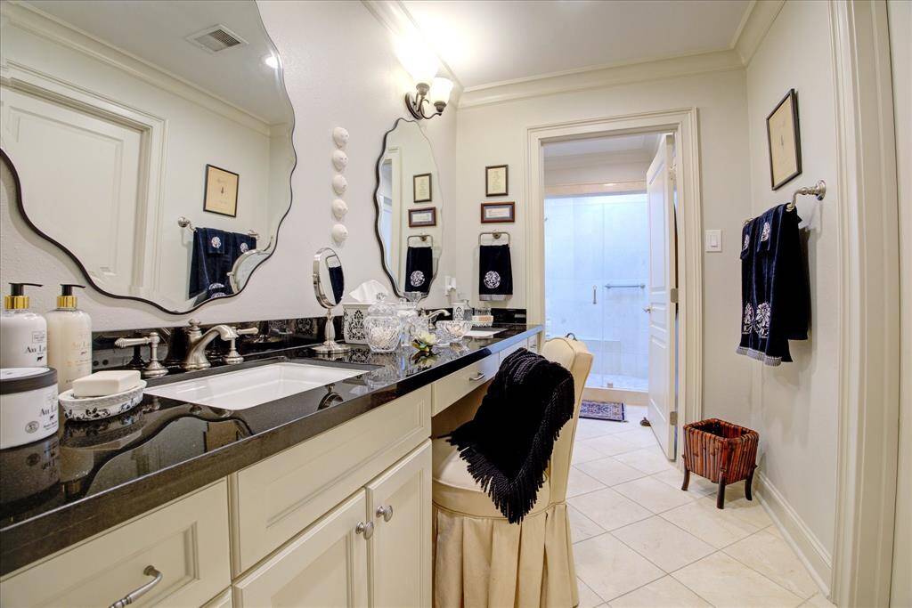 Double sinks, generous storage, marble floors and granite counters grace the primary bath.