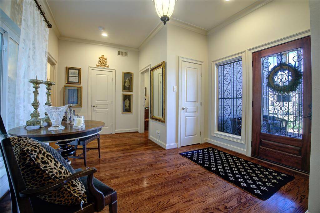 Spacious entry with oak floors and coat closet.