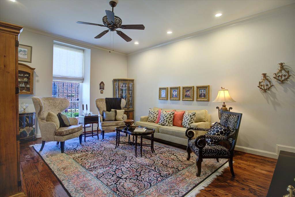 Another view of the living room with its tall ceilings and oak floors.