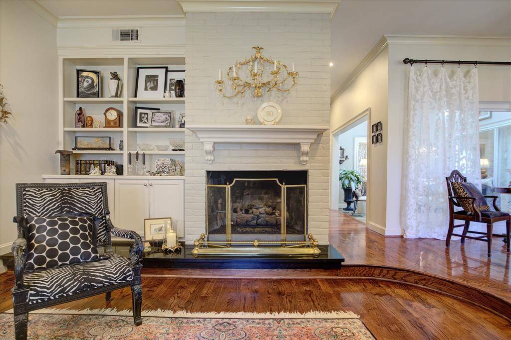 The focal point in this generous living room is the brick gas log fireplace with granite hearth.