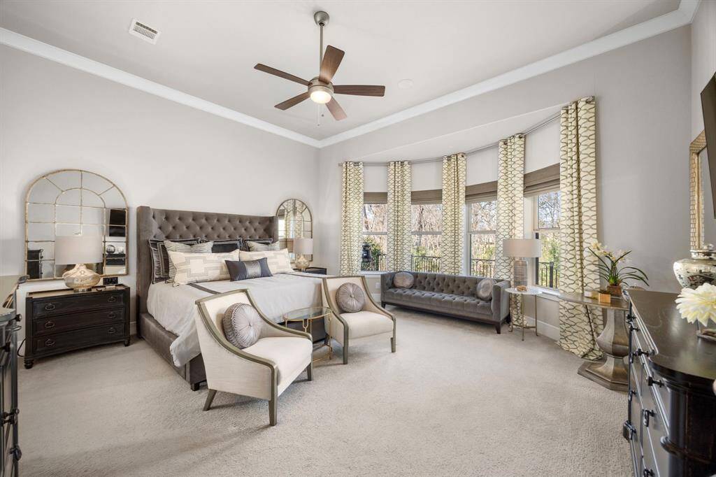 This spacious Primary bedroom features bay windows and ample natural light and ample space. The room offers an inviting atmosphere with sitting area near the Bay windows