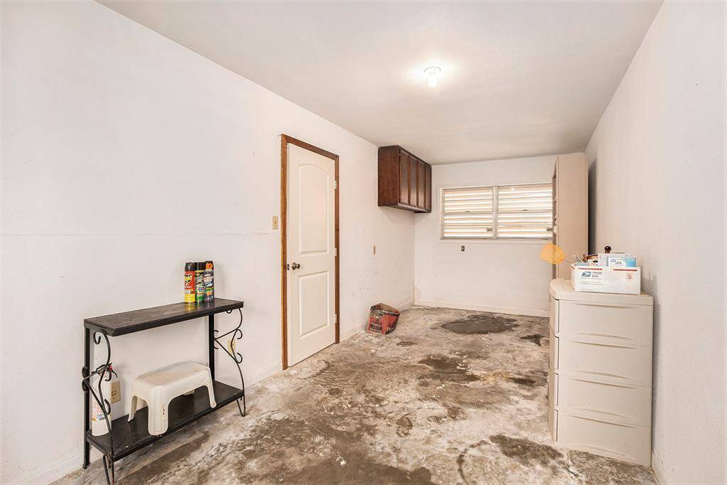 Versatile flex room with convenient storage between the main garage and house.