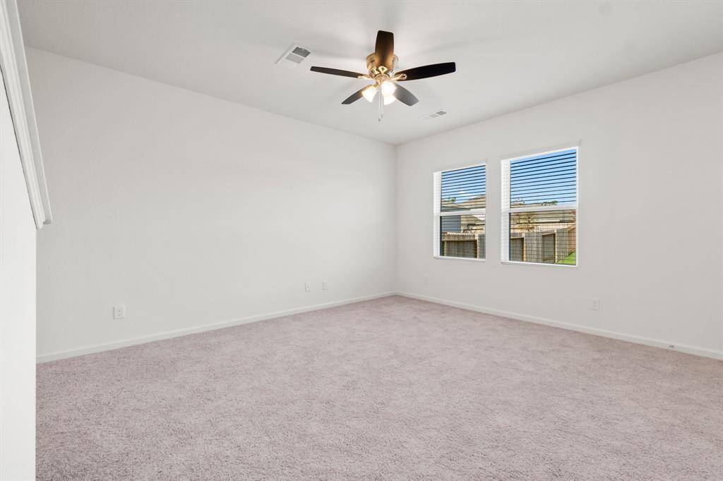 With double windows that flood the space with natural light and a ceiling fan to keep things cool and comfortable, this room is the ideal place for memorable moments with family and friends.