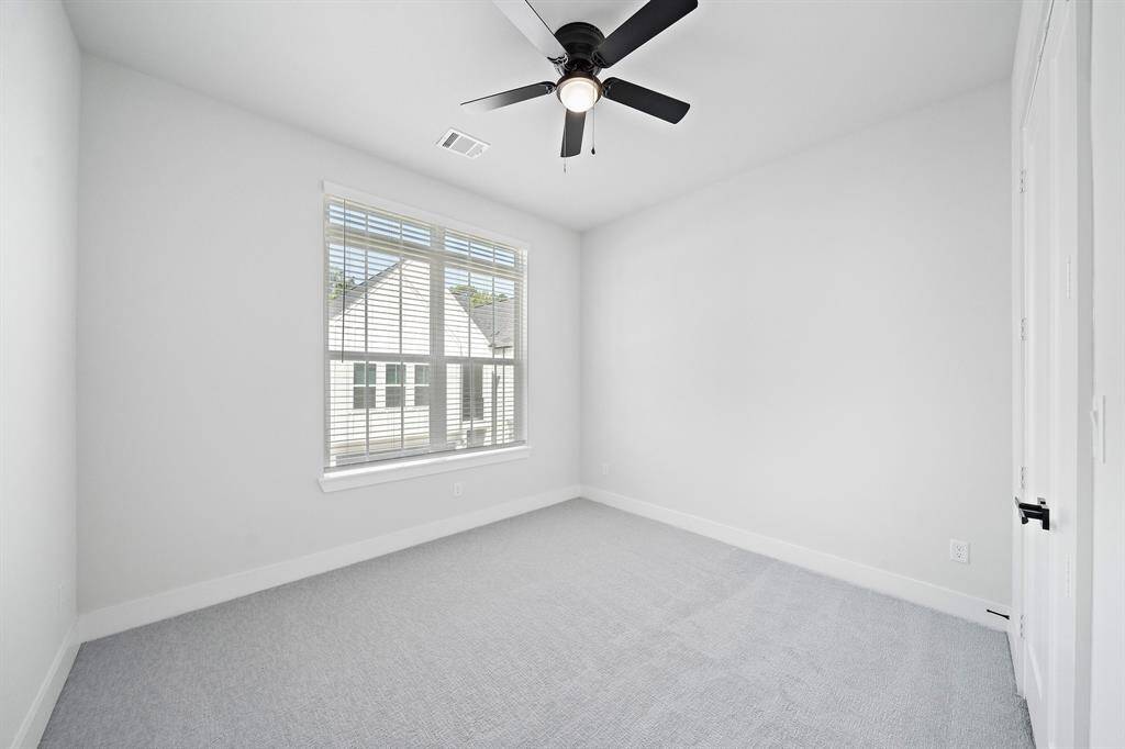 Secondary bedroom includes ceiling fan, blinds, walk-in closet, high ceiling, lost of space and natural light.