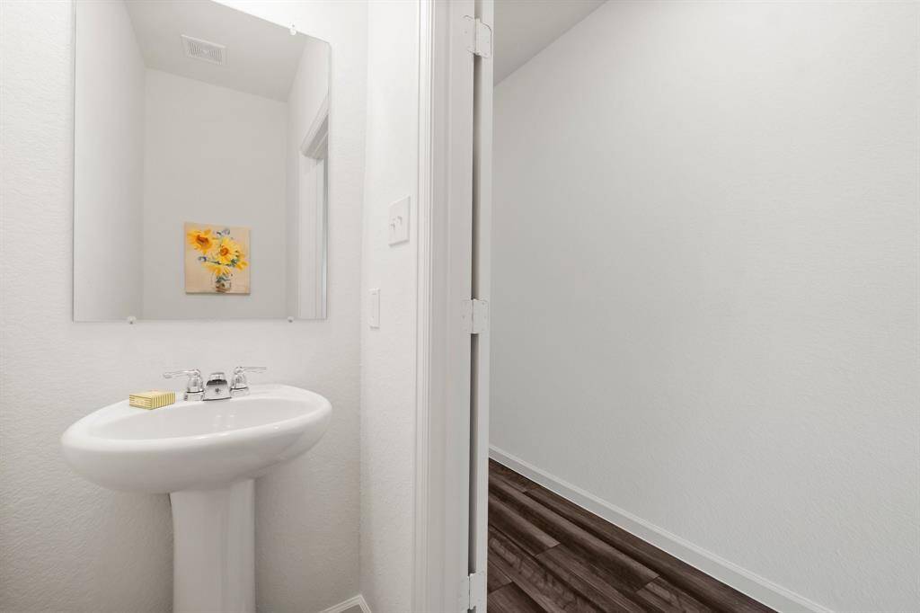 The powder room is conveniently located downstairs.