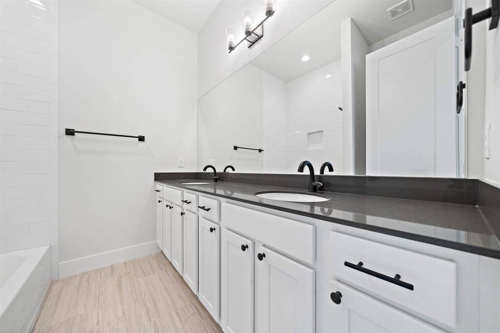 Secondary full bath is located on the second floor off the hallway. Tub/shower combo with tile wall, modern updates and soft close cabinets.