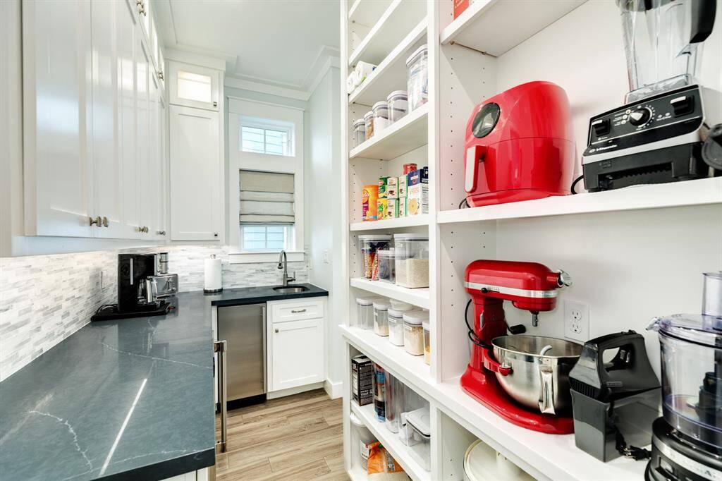 Look at all of this storage in the butler's pantry - well organized with open shelves for small appliances and cabinets for items to be stored out of view.