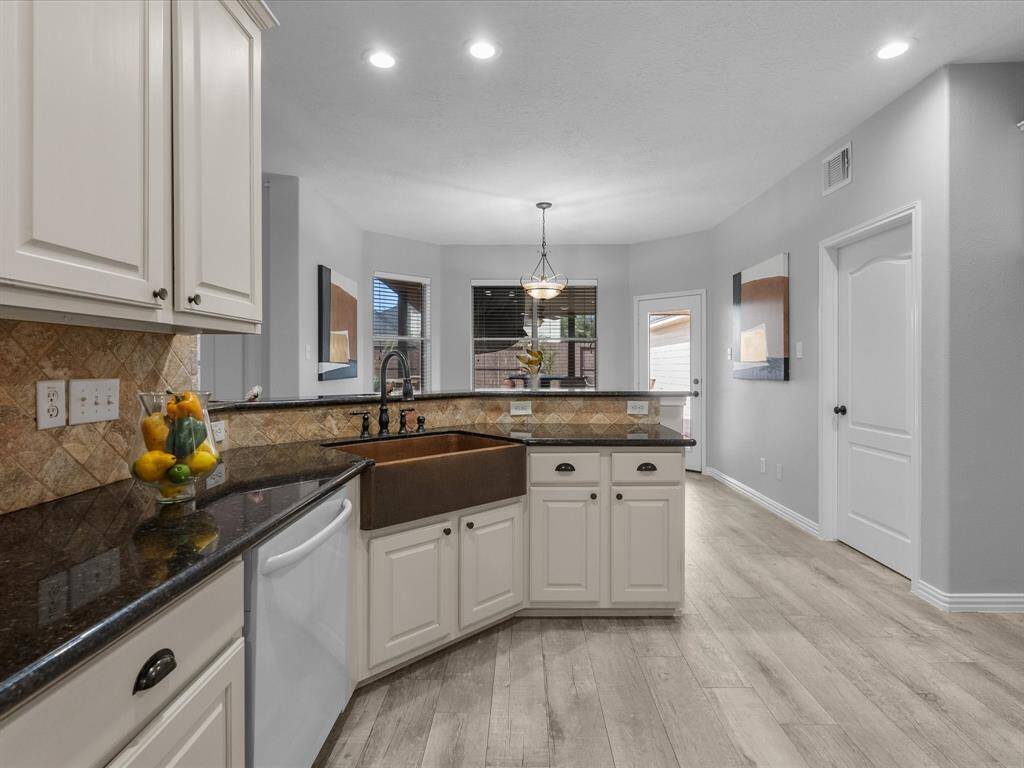 Spacious kitchen with an open layout and large windows bringing in natural light