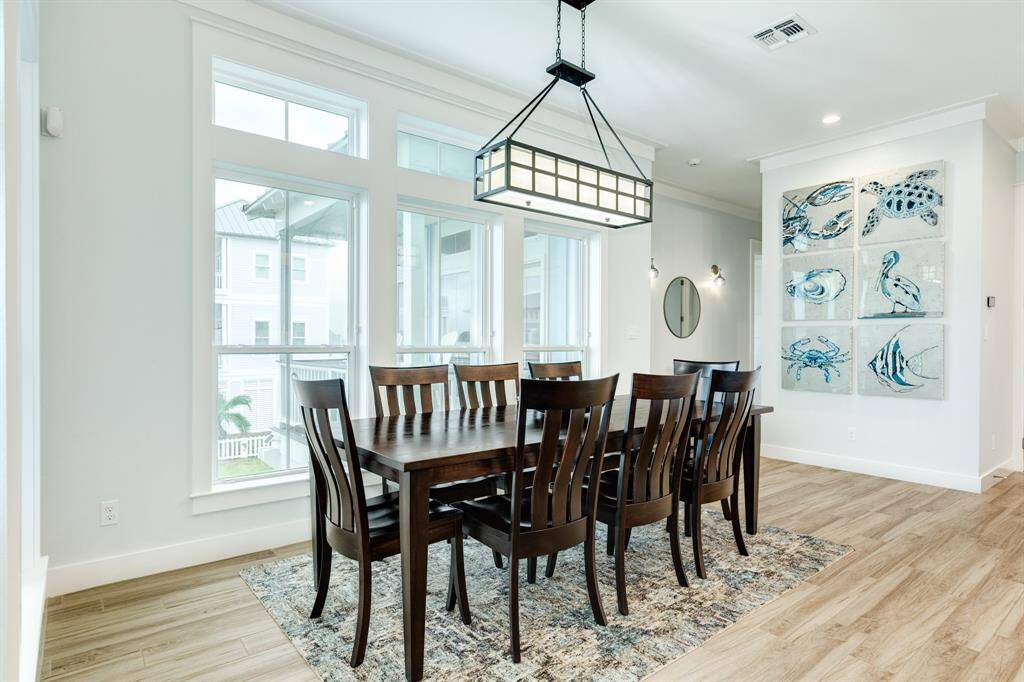 Custom art designed perfectly for this wall ties the coastal wildlife to the inside of the house.