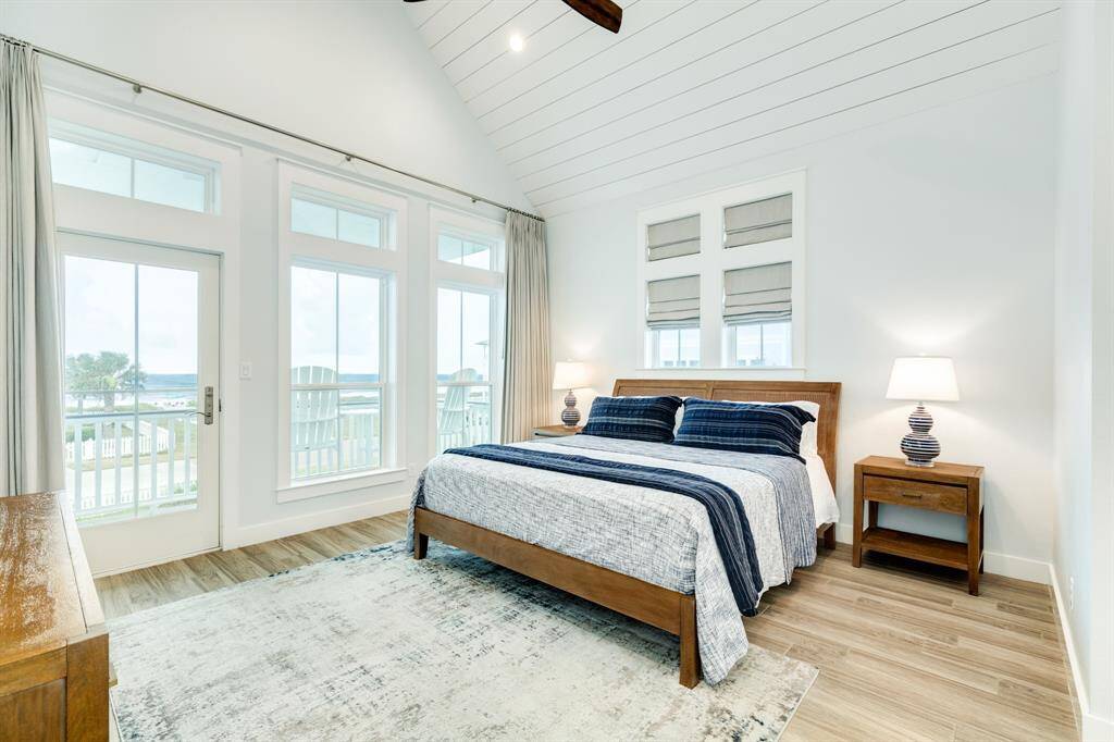 Large, lovely owners suite with vaulted ceiling covered in shiplap.  Private porch off the bedroom with blackout curtains.