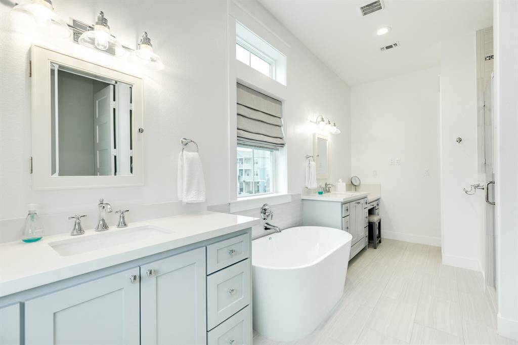 Gorgeous owners suite bathroom - large soaking tub with his and her vanities