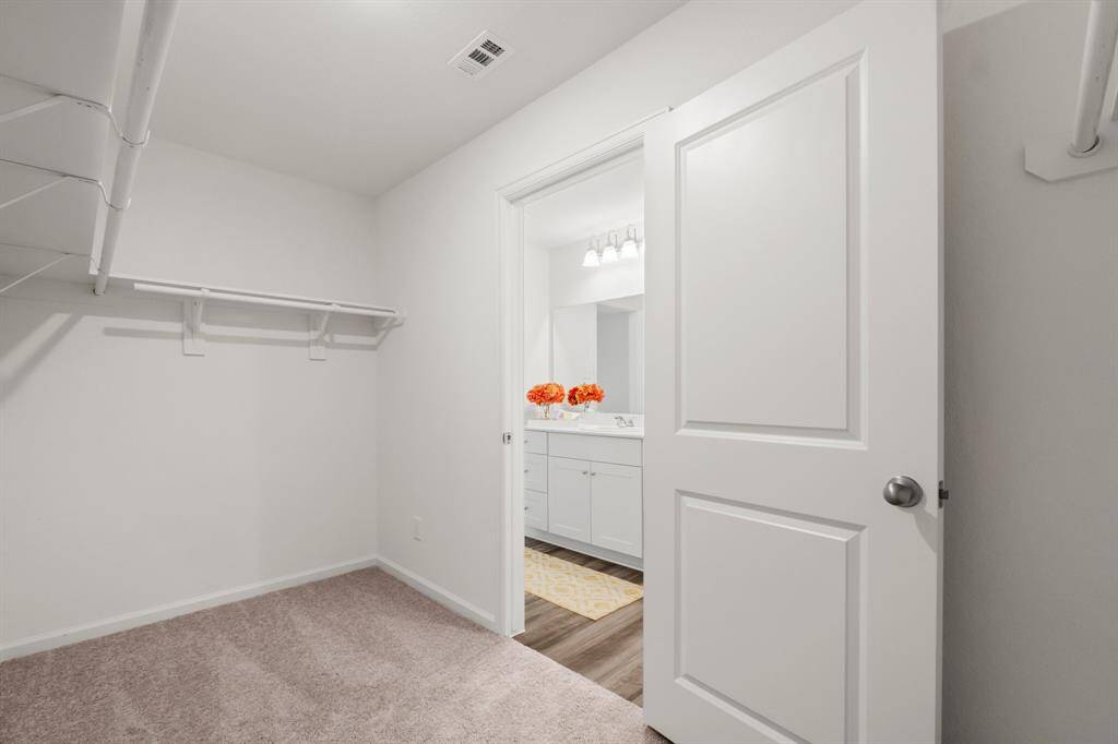 Enjoy organization and style with this impressive large walk-in closet.