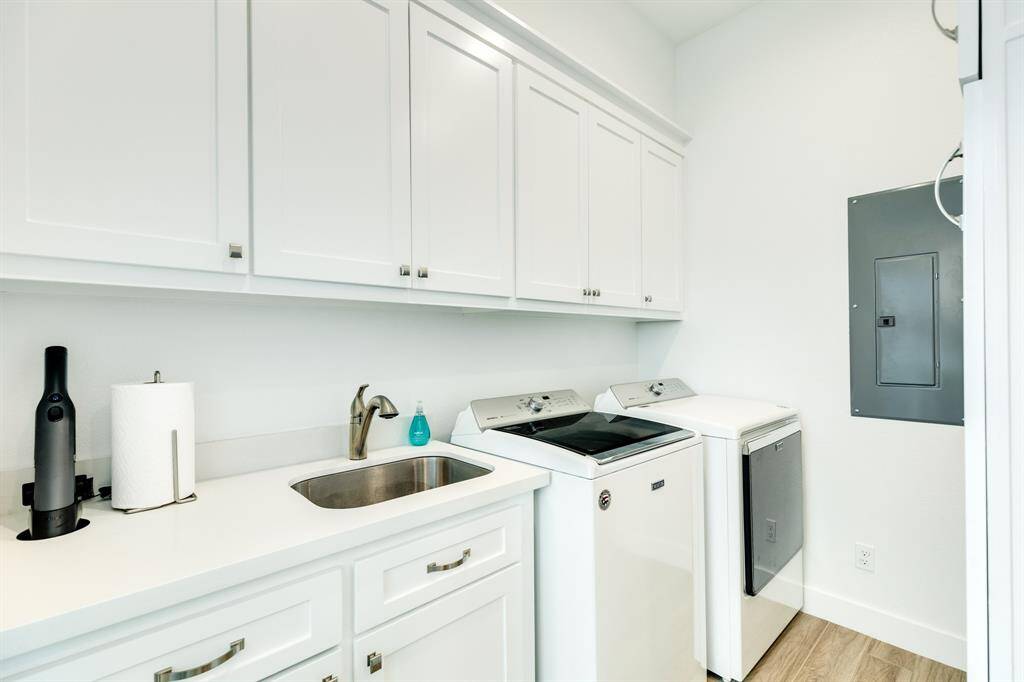 The laundry room is tucked away towards the rear of the house with access from the hallway and also from the owner suite bathroom, for convenience.  The rear porch is also through the laundry room - access to the HVAC units and the gas grill.