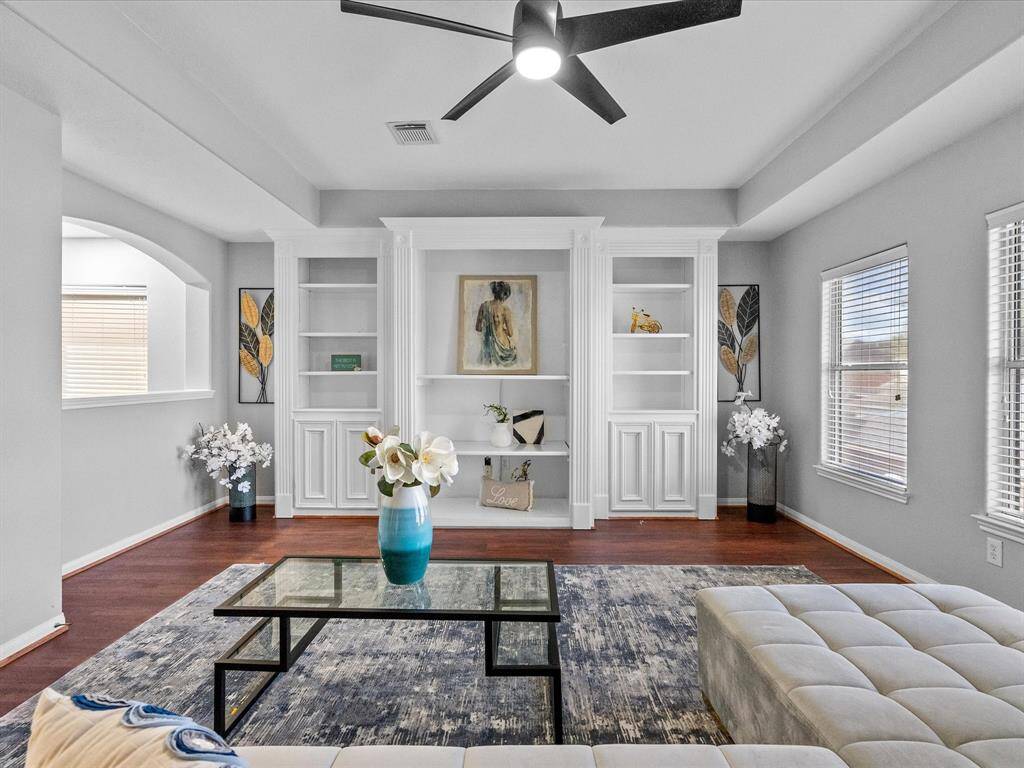 Sophisticated game room featuring built-in cabinetry and large windows for natural light