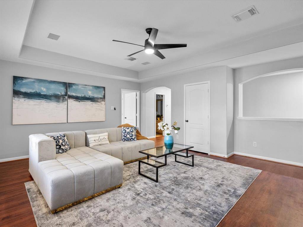 Open and inviting game room with a modern ceiling fan and plenty of space to entertain