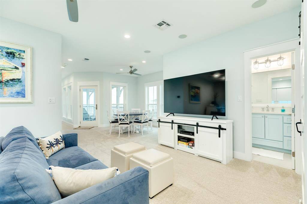 At the top of the stairs, you'll find the media space - a large area to watch your favorite Netflix series or your favorite team - again, look at all of the natural light coming in from the windows to views of the beach!