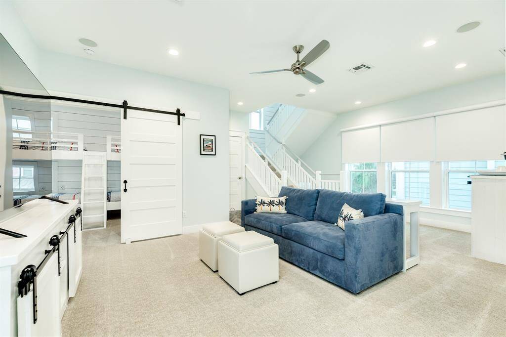 The bunk-room is off of this common space with a whimsical barn door - I wonder where that second set of stairs will lead to?