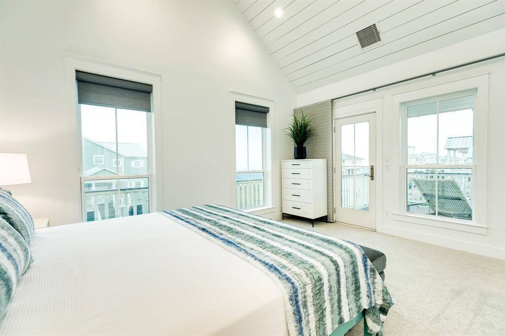 The first of two guest suites on this level - wonderful beach views from this bedroom with access to the porch.
