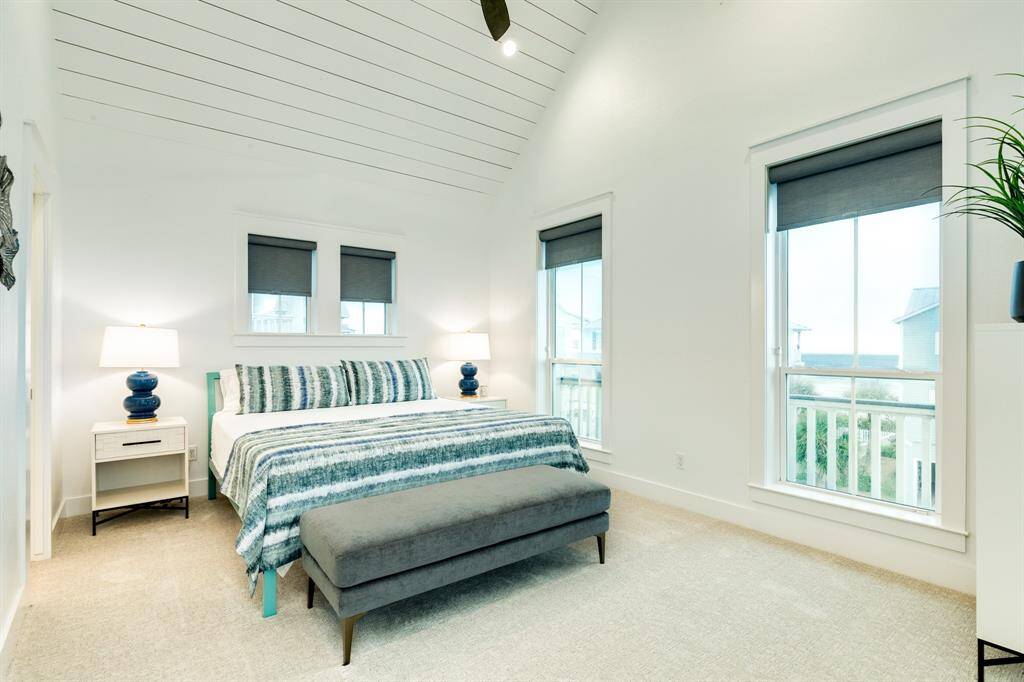 Another vaulted ceiling in this guest room - shiplap adds the beachy feel to this elegant space.
