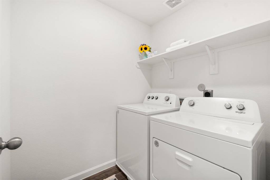 This charming upstairs laundry room is designed to make your laundry a breeze!  NEW washer and dryer included!