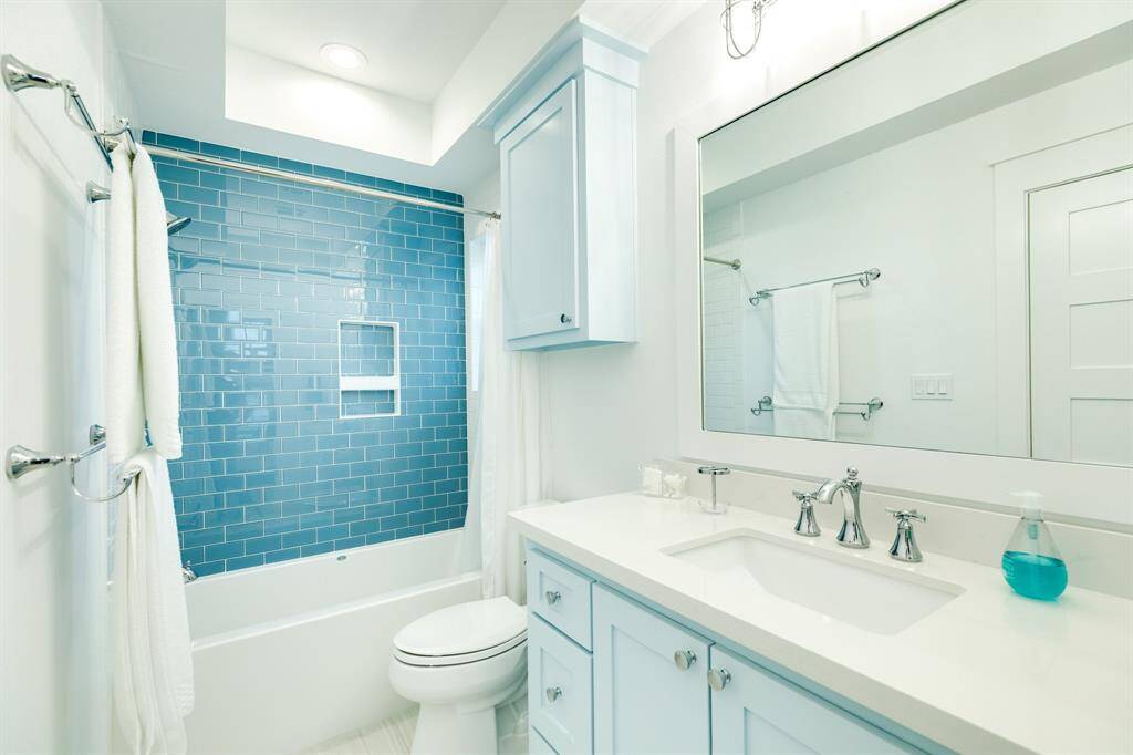 The bath for the bunk room has a tub for bathing the littles and is also the guest bath for those enjoying the media and game room