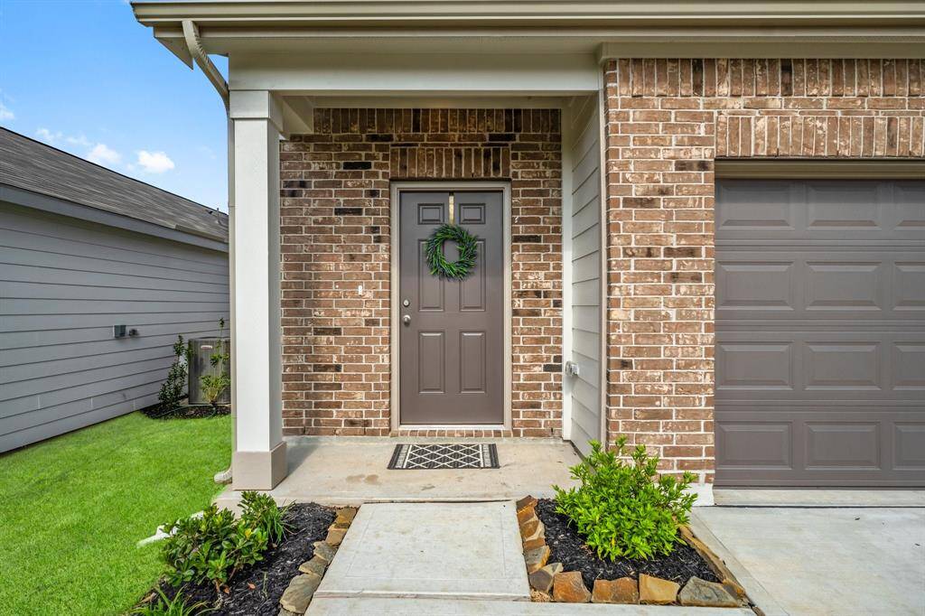 This charming covered front porch is inviting place to greet family and friends.
