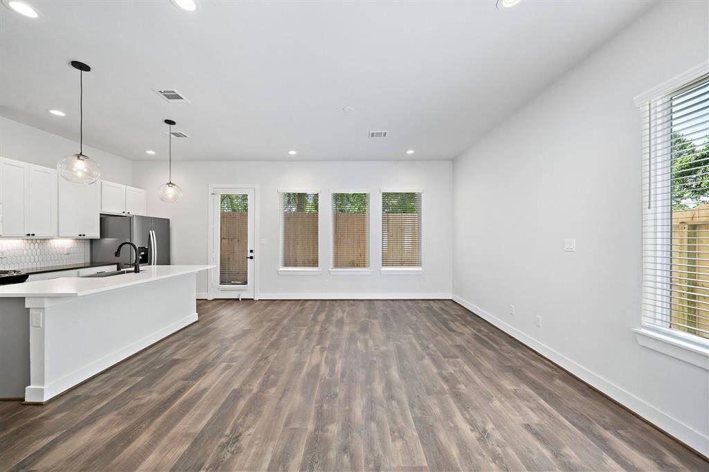Luxury vinyl flooring and high ceilings carry seamlessly into the kitchen/living area. Lots of space for your furniture!