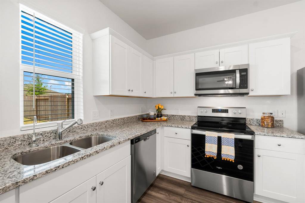 Step into the stunning kitchen, a true centerpiece featuring beautiful white shaker cabinets that provide ample storage and a sleek, sophisticated look, as well as, lovely granite countertops.