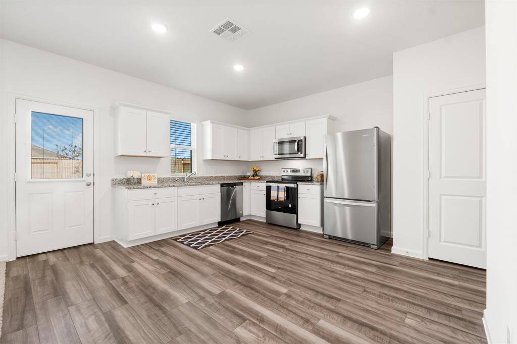 Luxury vinyl flooring throughout the kitchen and dining room adds warmth and beauty to this space!  Stainless steel appliances are included in this eat-in kitchen!