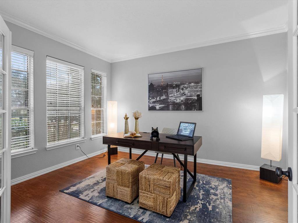 Bright home office with French doors and large windows.