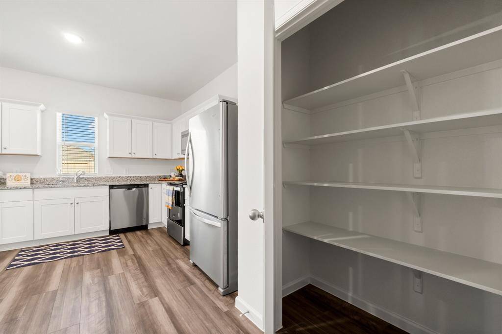 This generously sized pantry offers ample room to store everything from canned goods to bulk items.