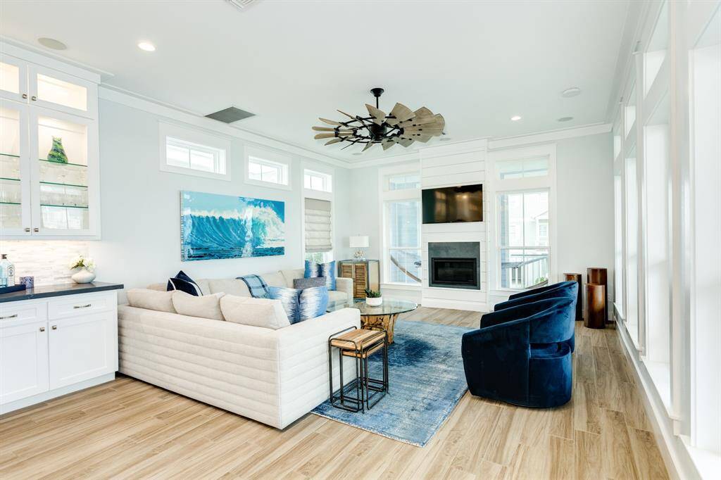 The TV and fireplace are on the south wall for convenient viewing.  Dry bar between the kitchen and the living room.