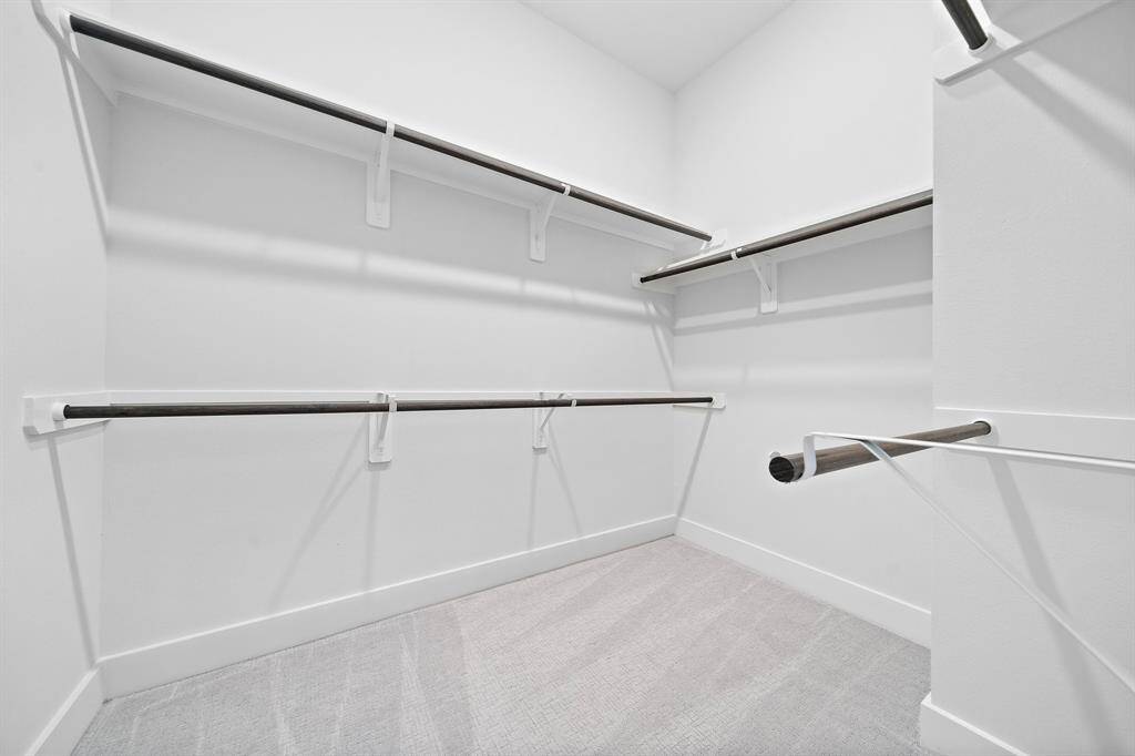 It wouldn't be a primary suite without a large walk-in closet. Lots of overhead storage space available as well.