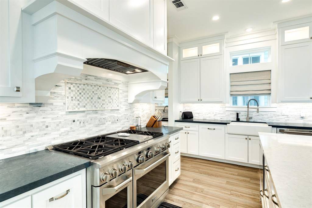 Gourmet kitchen! Marble backsplash.  Two different countertops for maximum effect.  48" range with gas cooktop and double ovens.