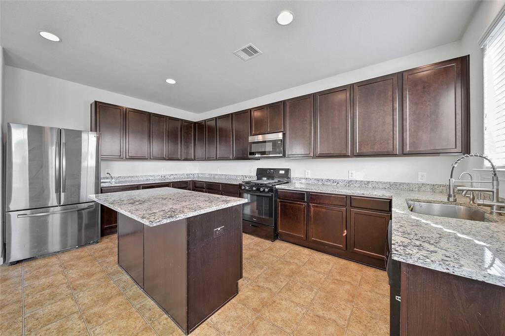 Large island kitchen updated with granite.