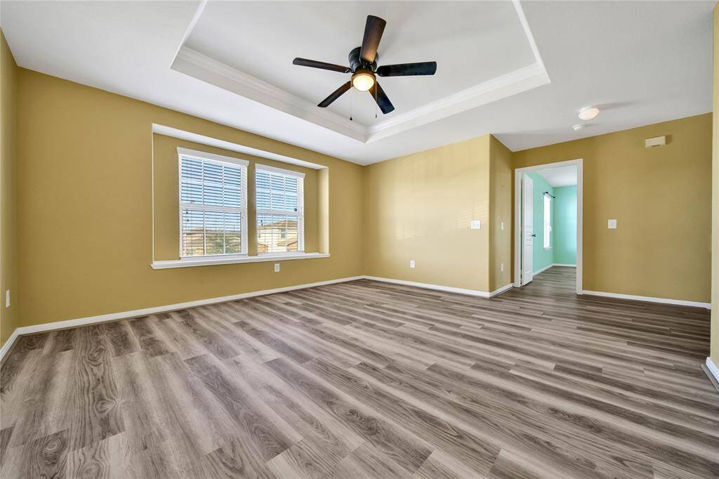 Game room has a lot of natural light, trayed ceiling and no carpet