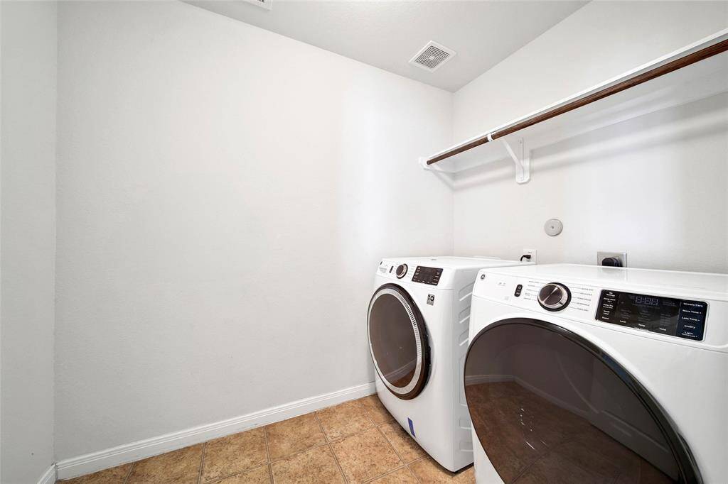 Second floor laundry equipped with machines.