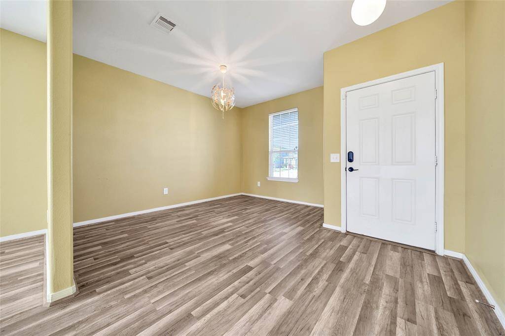 Open floor plan with a wall giving some separation for an office space.